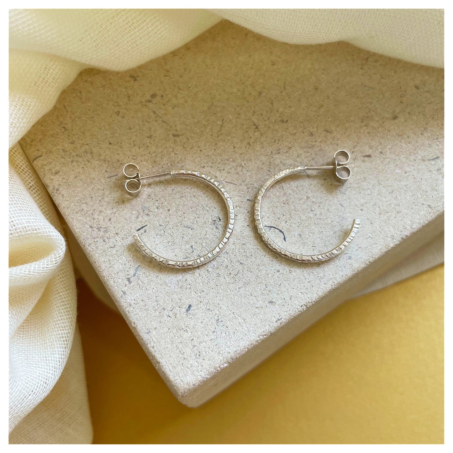 Sterling Silver Textured Hoop Earrings.