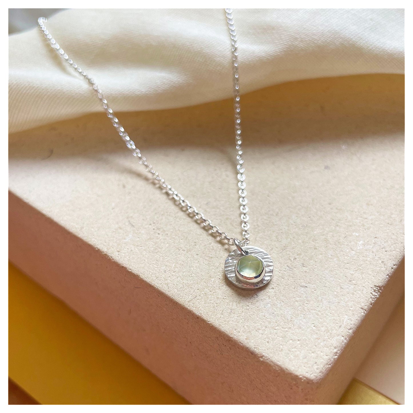 Sterling Silver and Prehnite Hammered Disc Pendant.