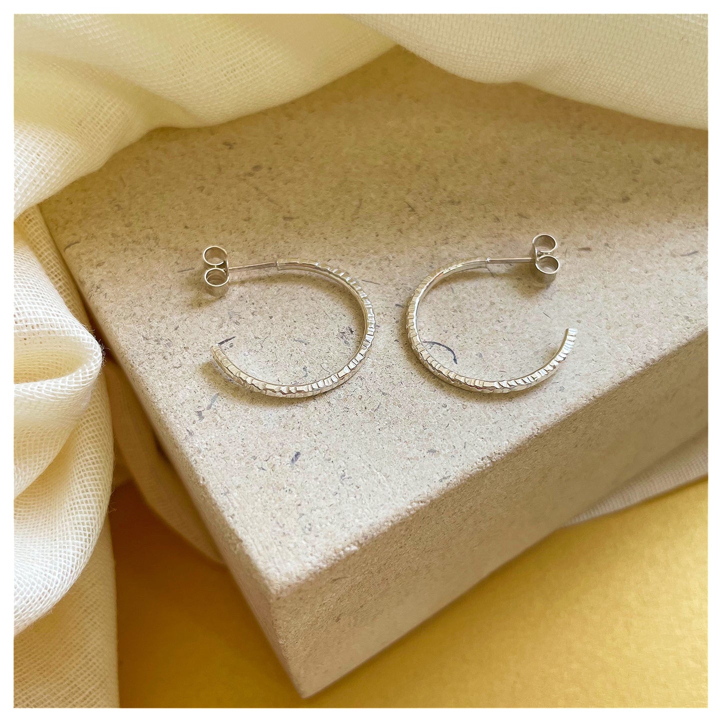 Sterling Silver Textured Hoop Earrings.