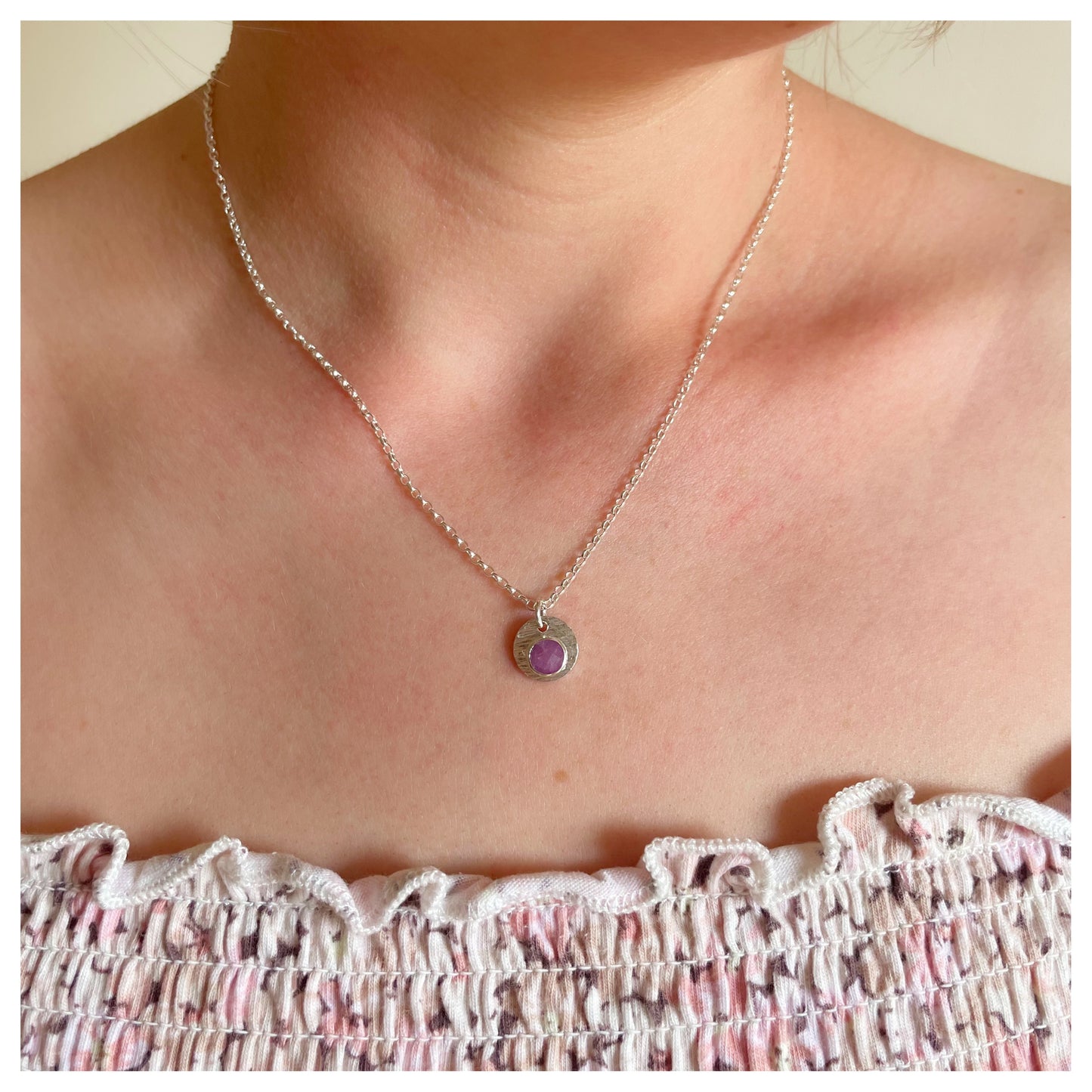 Sterling Silver and Ruby Hammered Disc Pendant.