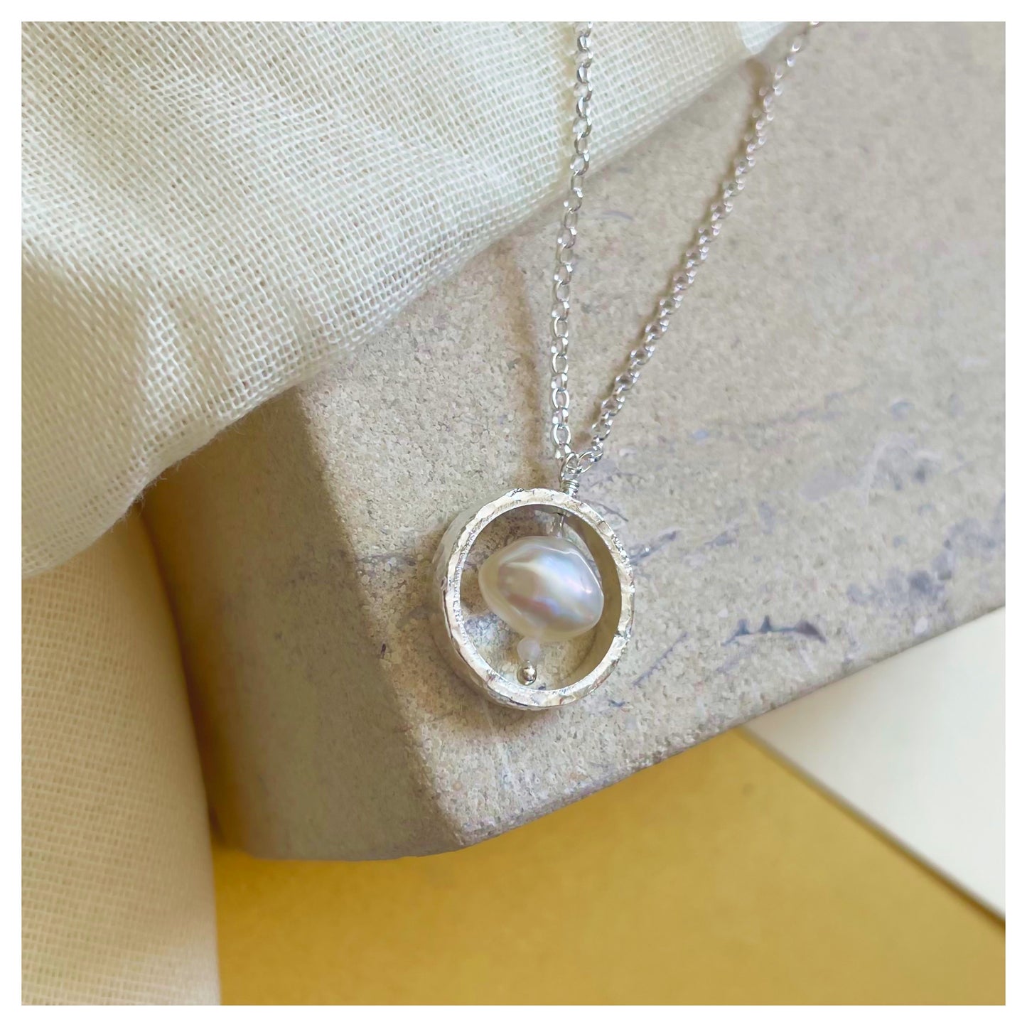 Sterling Silver Textured Circle Pendant Necklace with Freshwater Pearl and Moonstone.