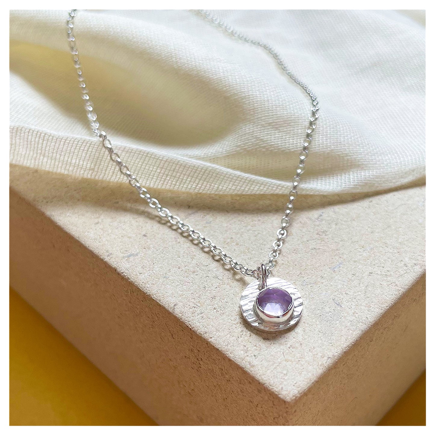 Sterling Silver and Brazilian Amethyst Hammered Disc Pendant.