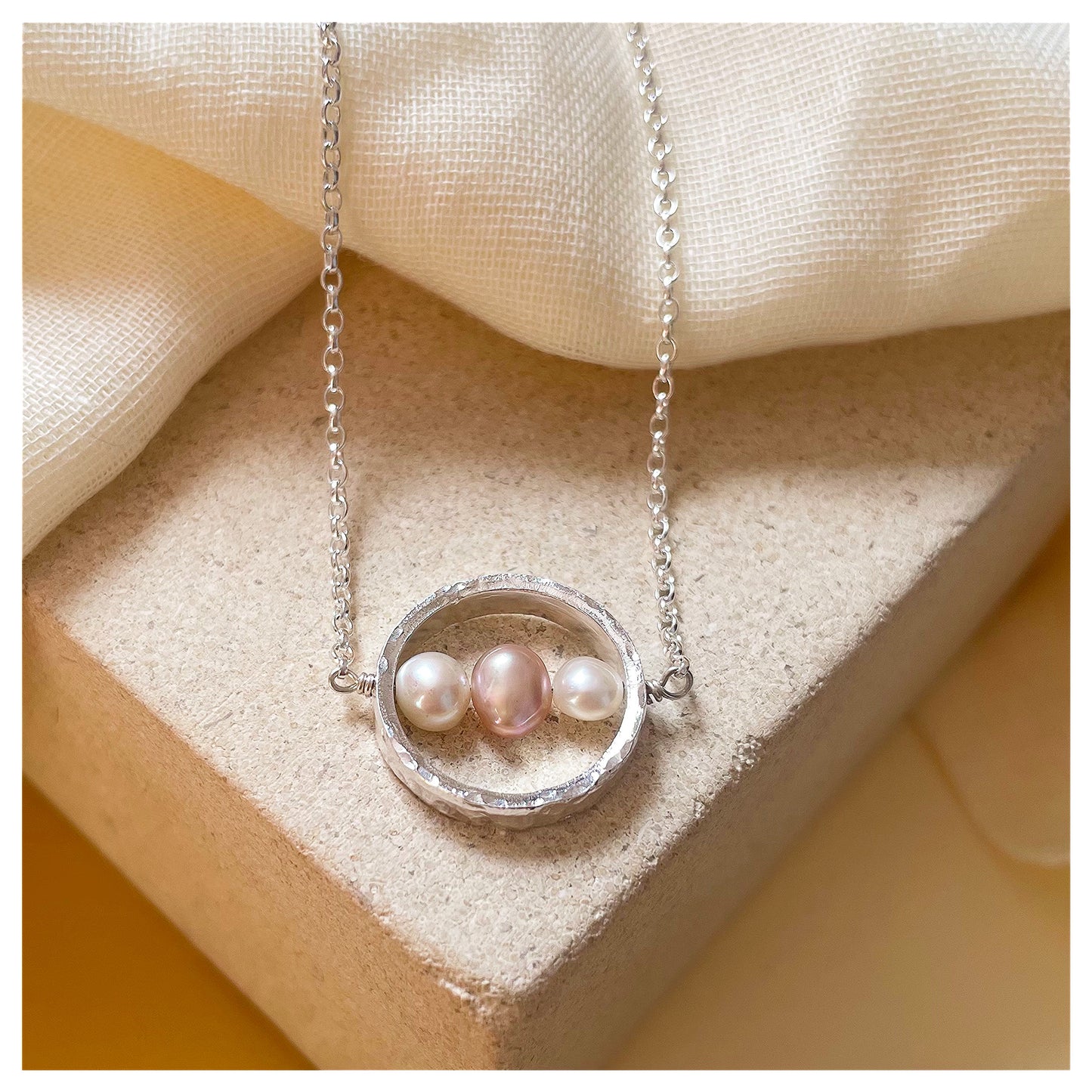 Sterling Silver Textured Circle Bar Pendant Necklace with Pink and White Freshwater Pearls.