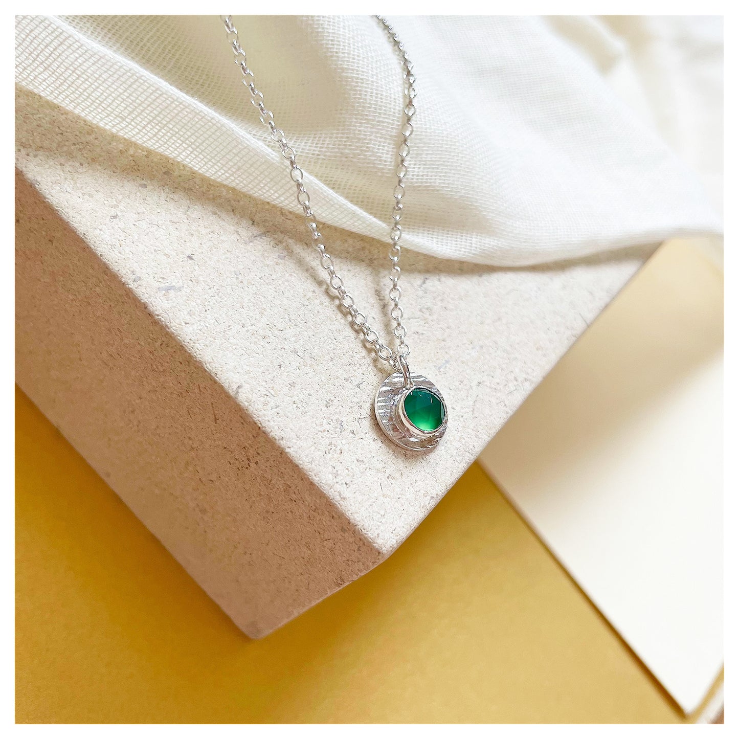 Sterling Silver and Green Onyx Hammered Disc Pendant.