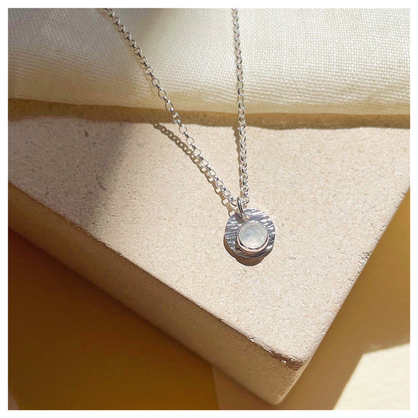 Sterling Silver and White Opal Hammered Disc Pendant.