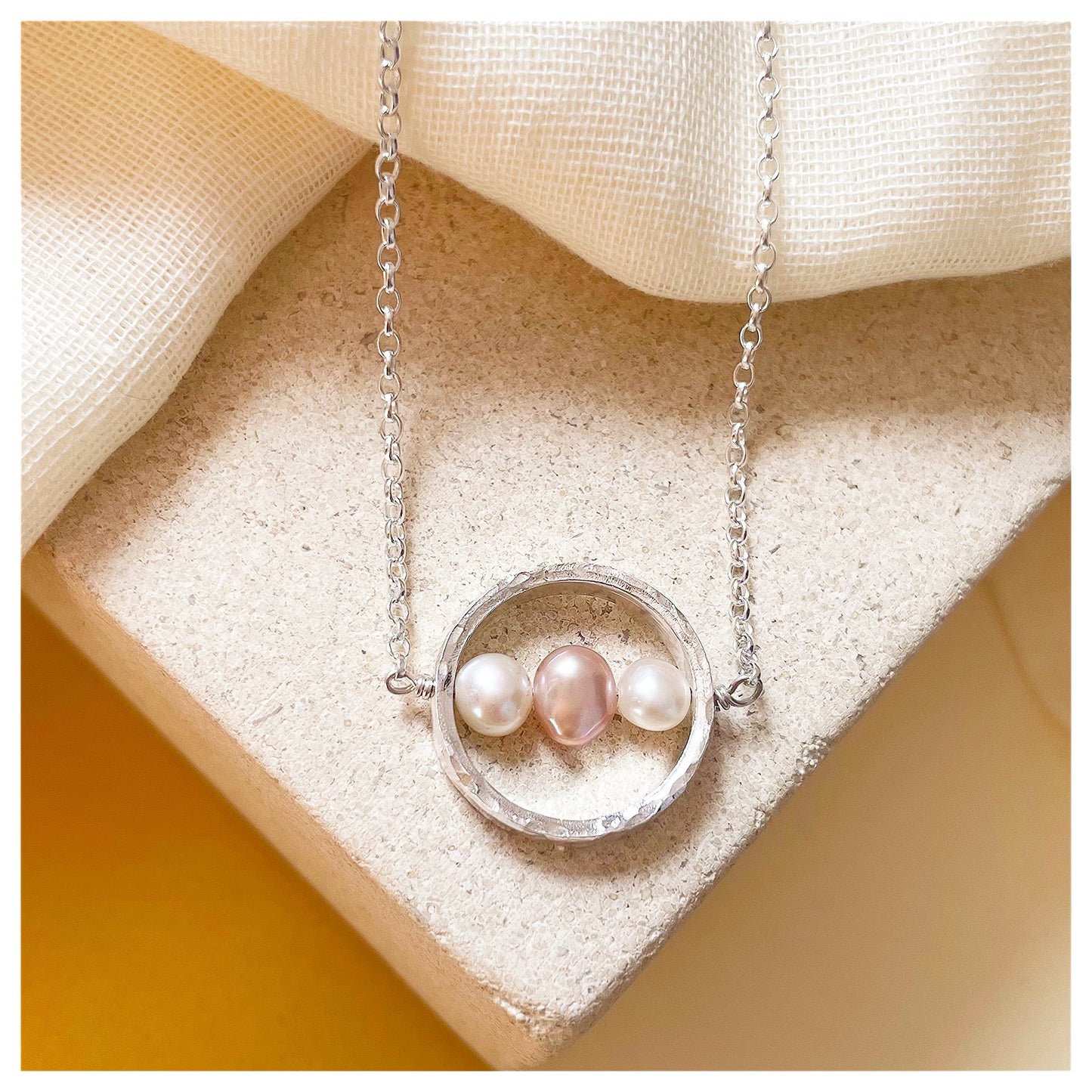 Sterling Silver Textured Circle Bar Pendant Necklace with Pink and White Freshwater Pearls.