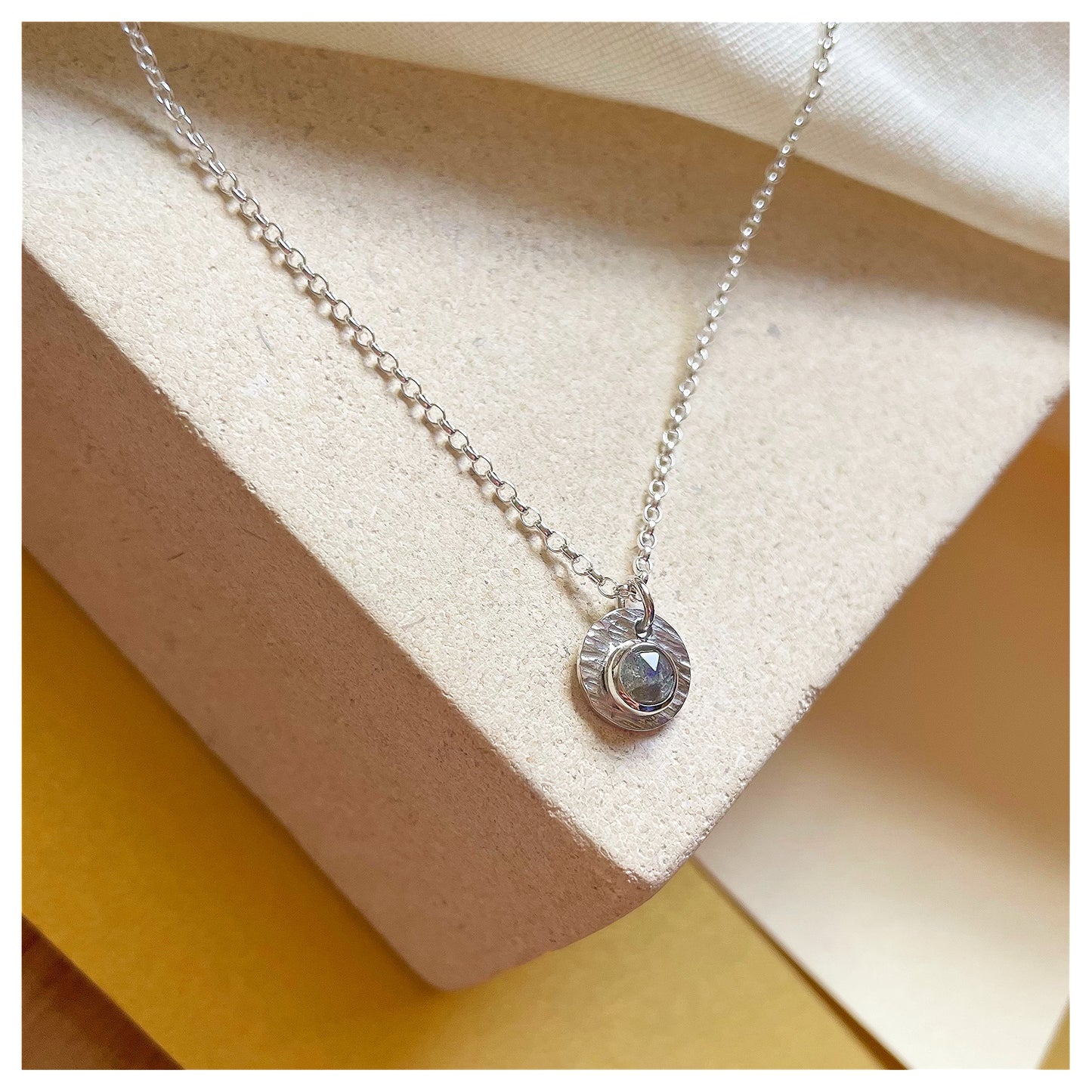 Sterling Silver and Labradorite Hammered Disc Pendant.