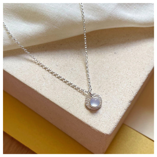 Sterling Silver and Chalcedony Hammered Disc Pendant.