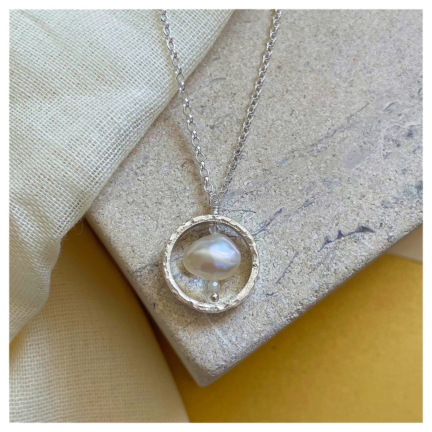 Sterling Silver Textured Circle Pendant Necklace with Freshwater Pearl and Moonstone.