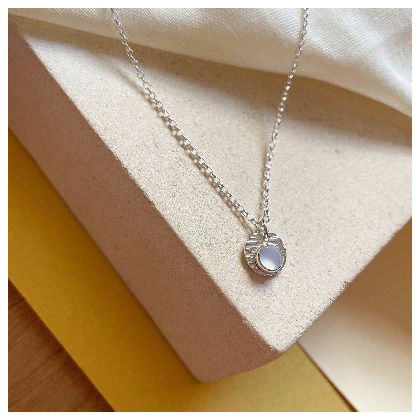 Sterling Silver and Chalcedony Hammered Disc Pendant.