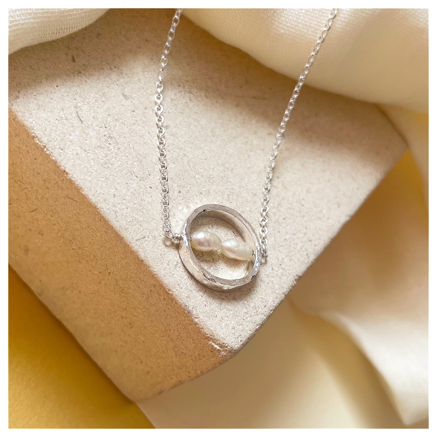 Sterling Silver Textured Circle Bar Pendant Necklace with Freshwater Rice Pearls.