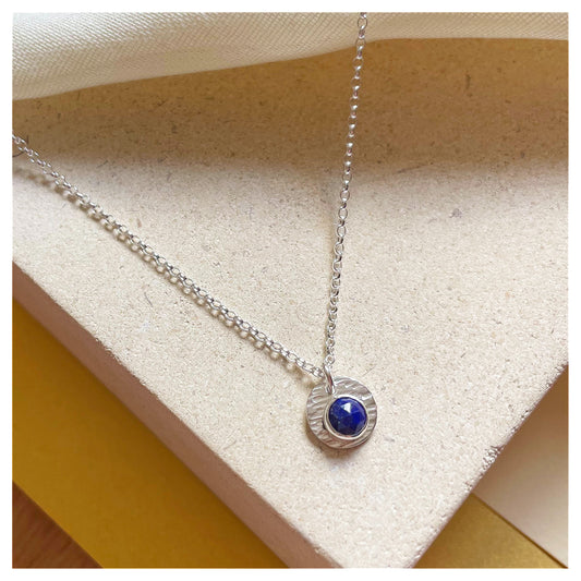 Sterling Silver and Lapis Lazuli Hammered Disc Pendant.