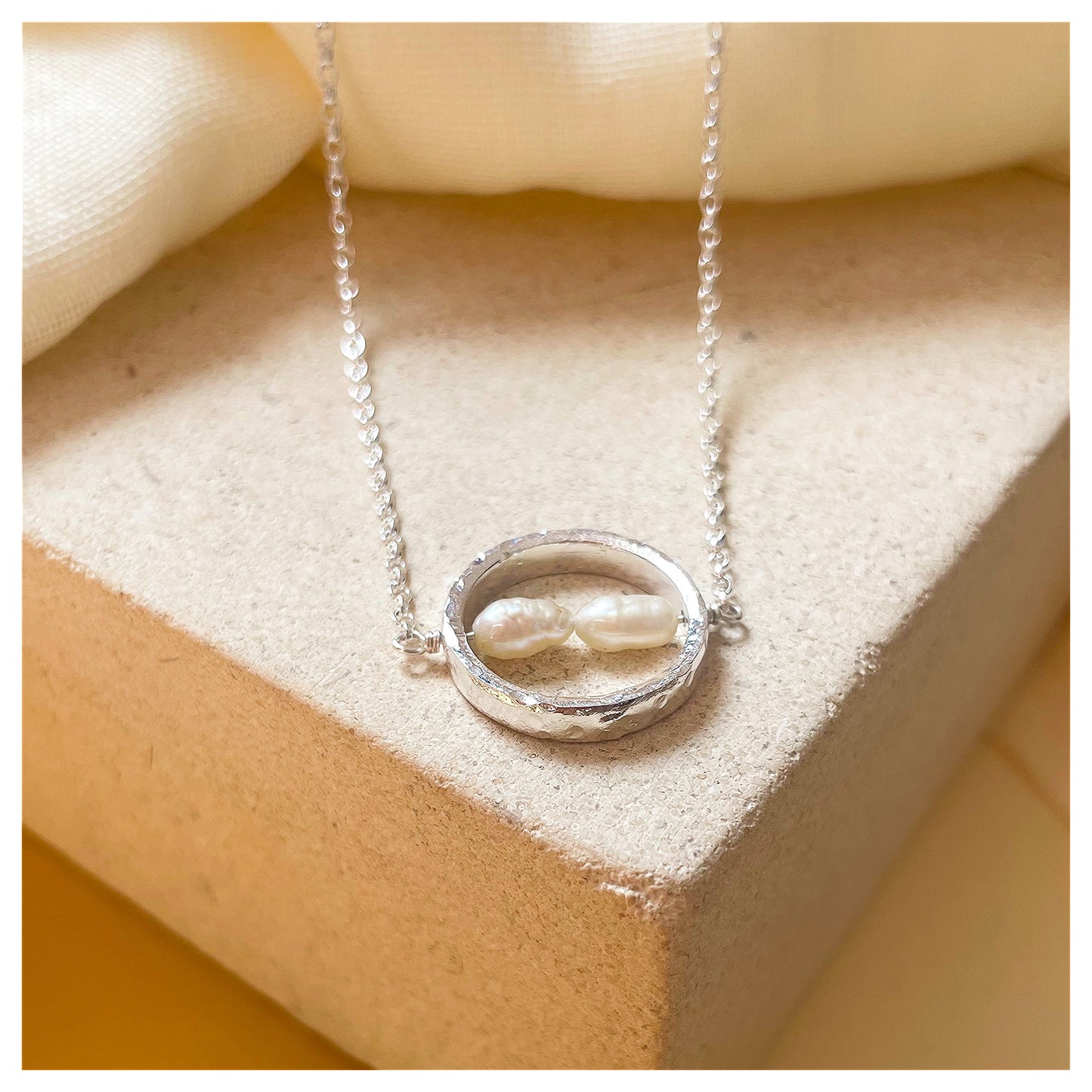 Sterling Silver Textured Circle Bar Pendant Necklace with Freshwater Rice Pearls.