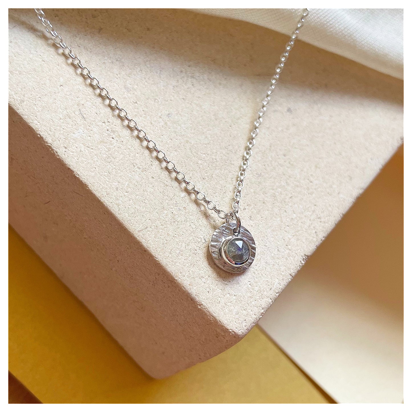 Sterling Silver and Labradorite Hammered Disc Pendant.