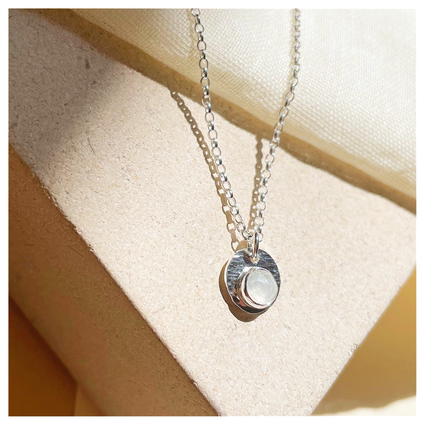 Sterling Silver and White Opal Hammered Disc Pendant.