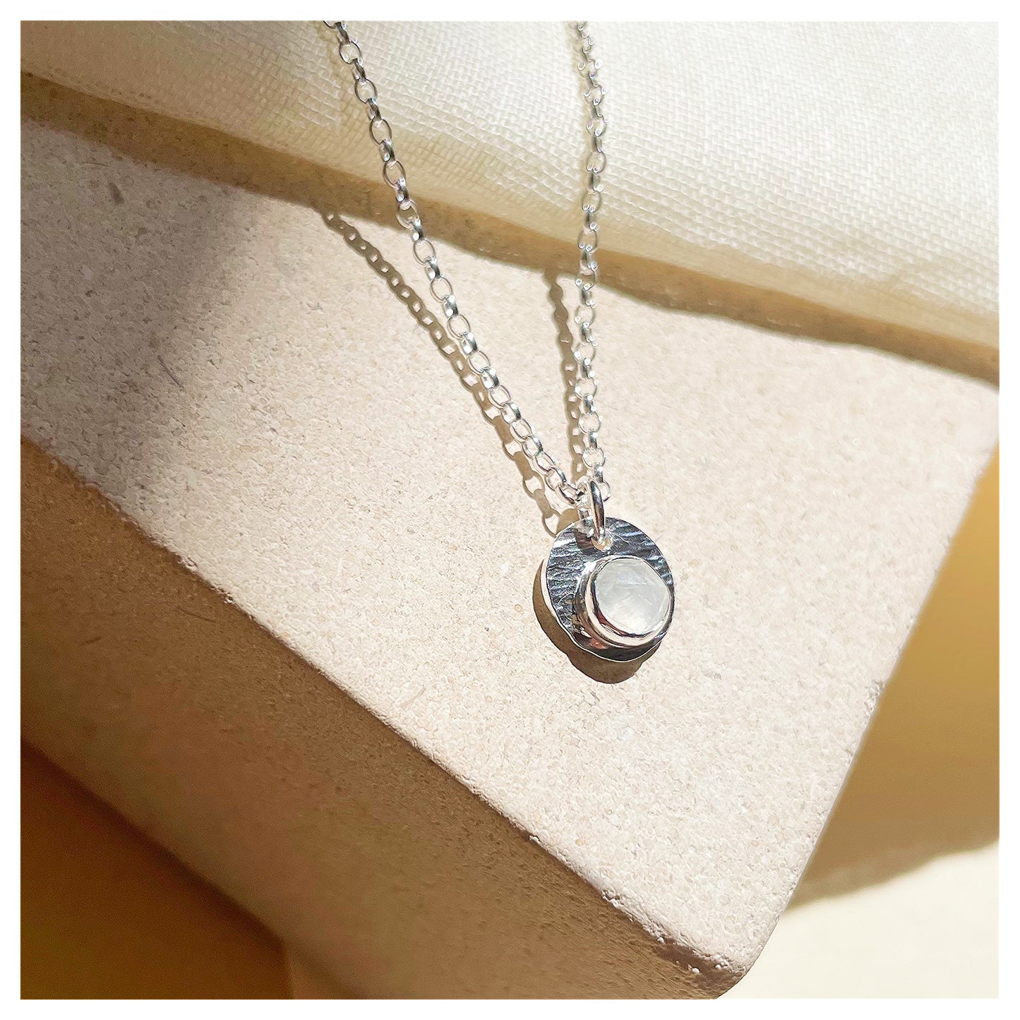 Sterling Silver and White Opal Hammered Disc Pendant.
