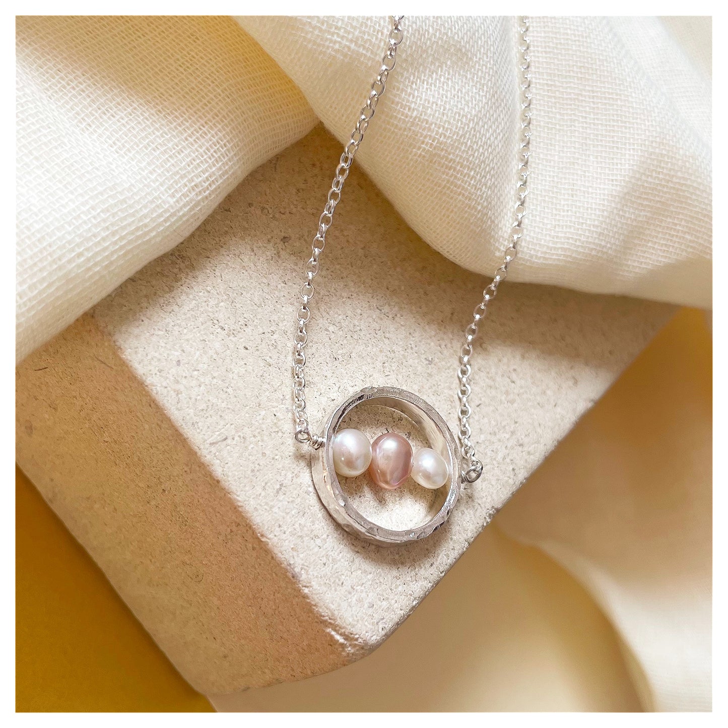 Sterling Silver Textured Circle Bar Pendant Necklace with Pink and White Freshwater Pearls.