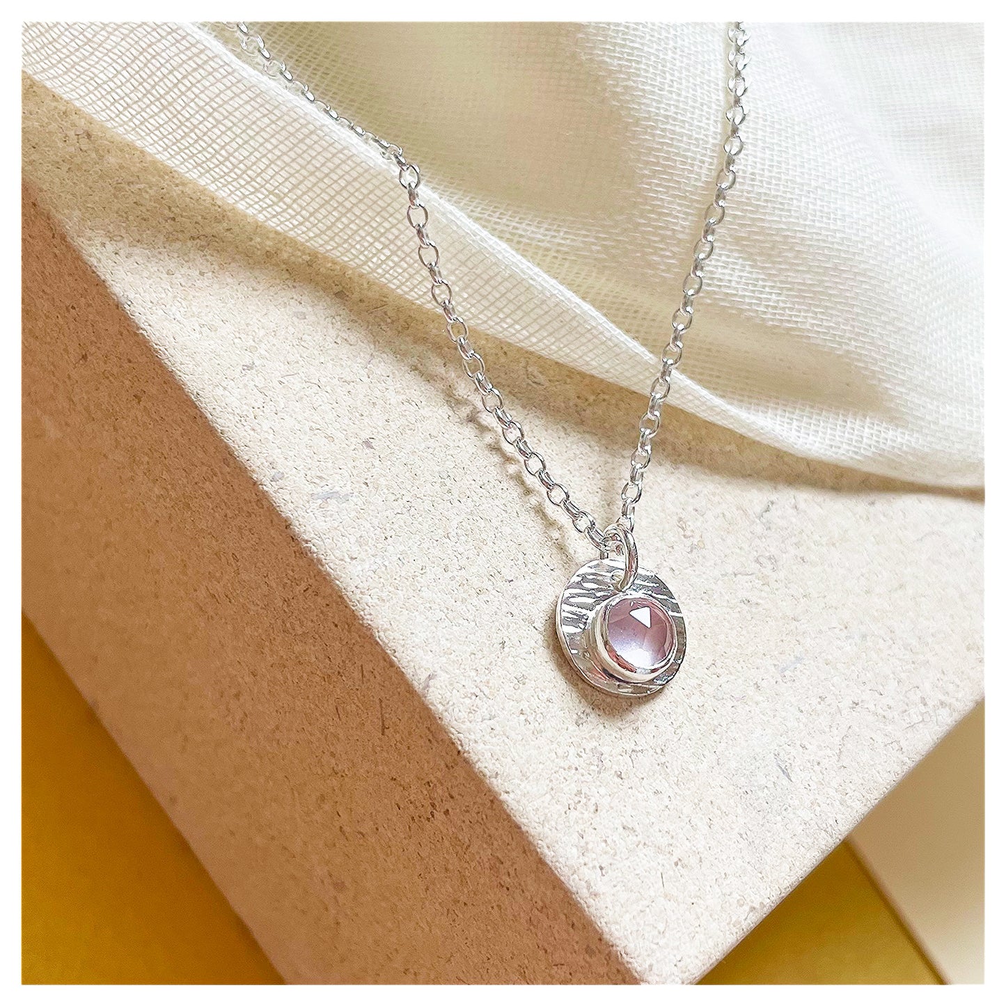 Sterling Silver and Rose Quartz Hammered Disc Pendant.