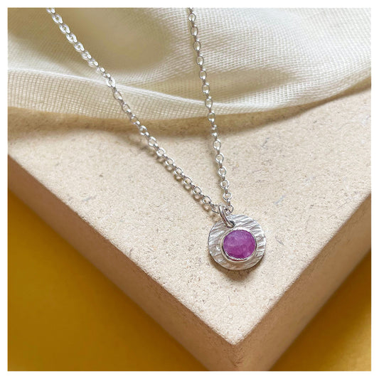 Sterling Silver and Ruby Hammered Disc Pendant.