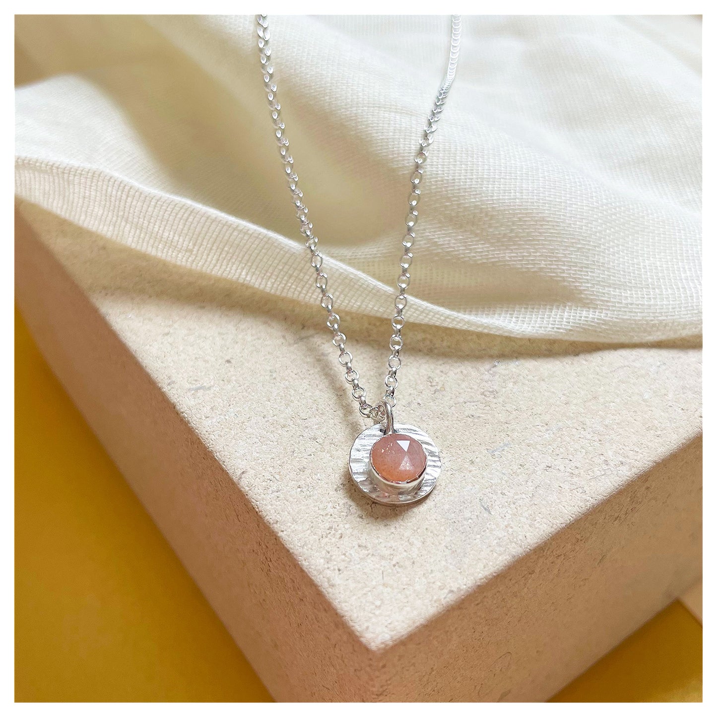 Sterling Silver and Peach Moonstone Hammered Disc Pendant.