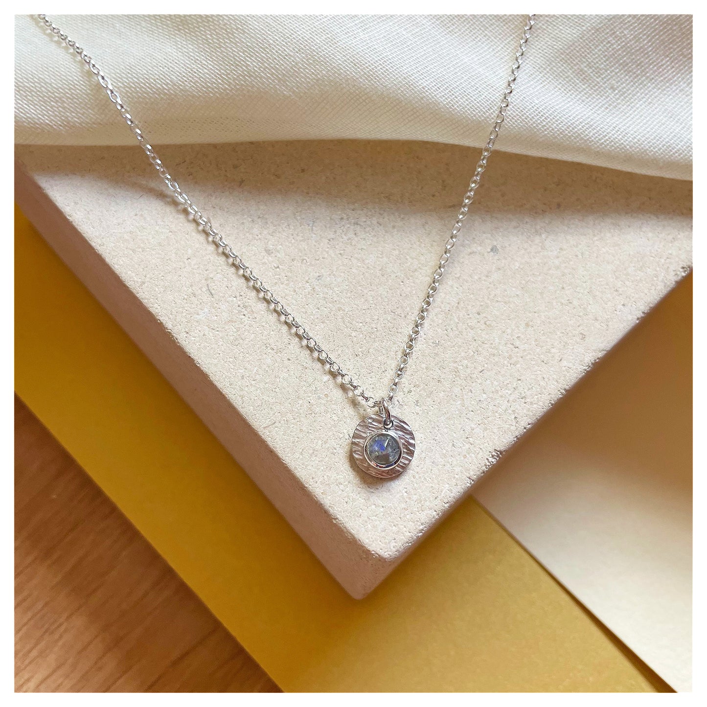 Sterling Silver and Labradorite Hammered Disc Pendant.