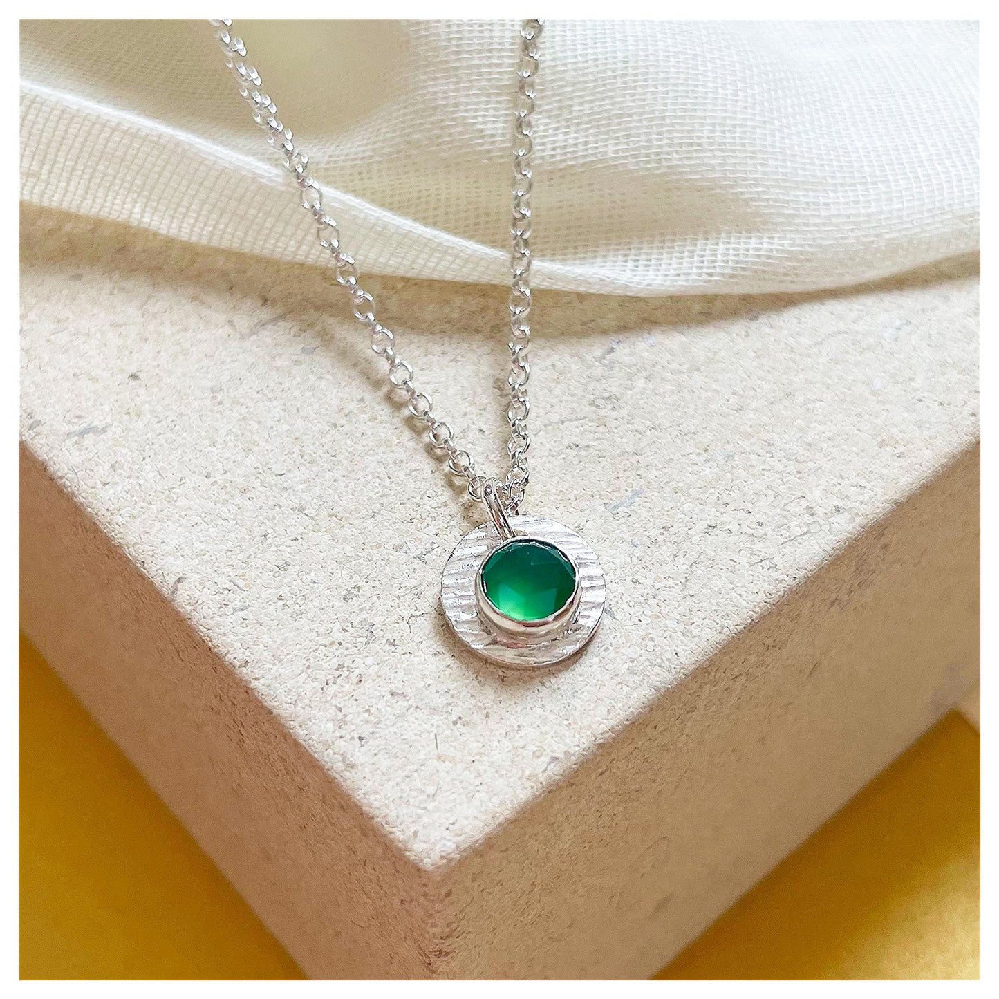 Sterling Silver and Green Onyx Hammered Disc Pendant.