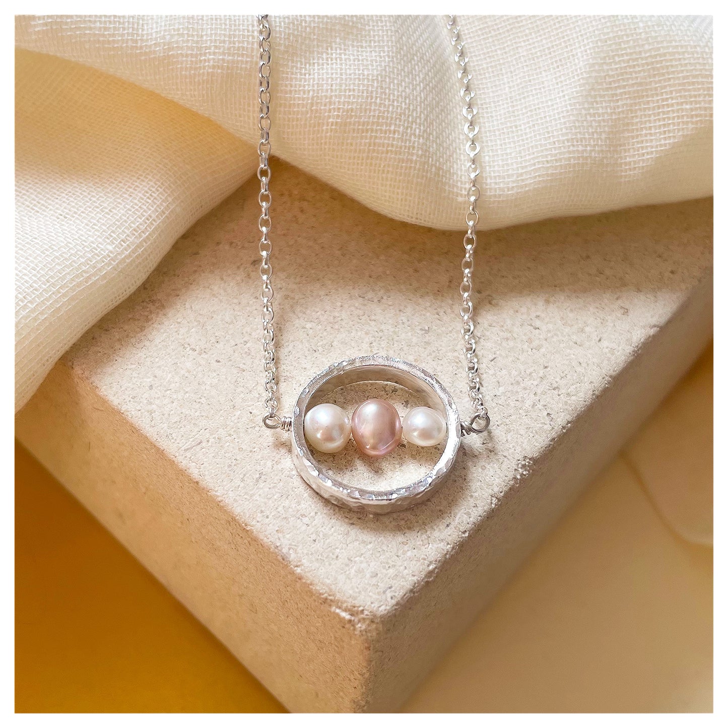 Sterling Silver Textured Circle Bar Pendant Necklace with Pink and White Freshwater Pearls.