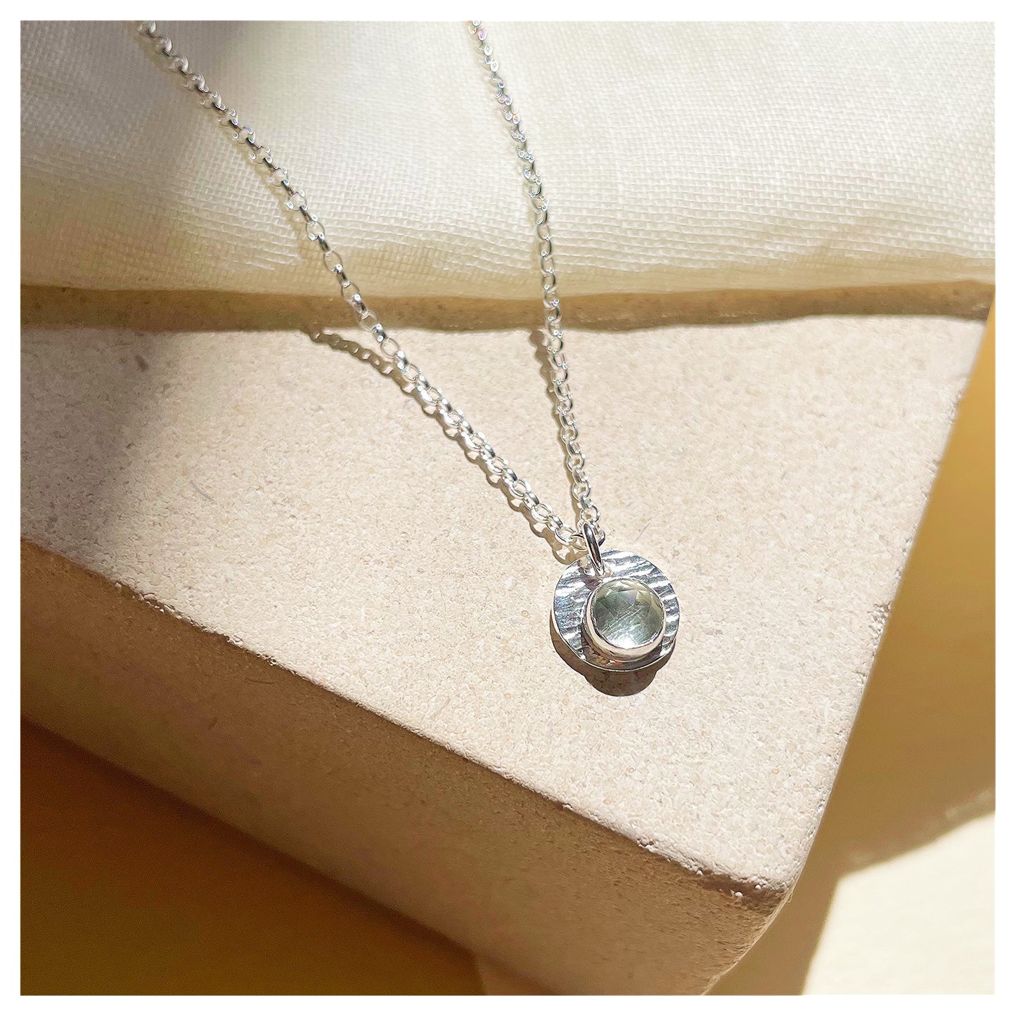 Sterling Silver and Green Amethyst Hammered Disc Pendant.
