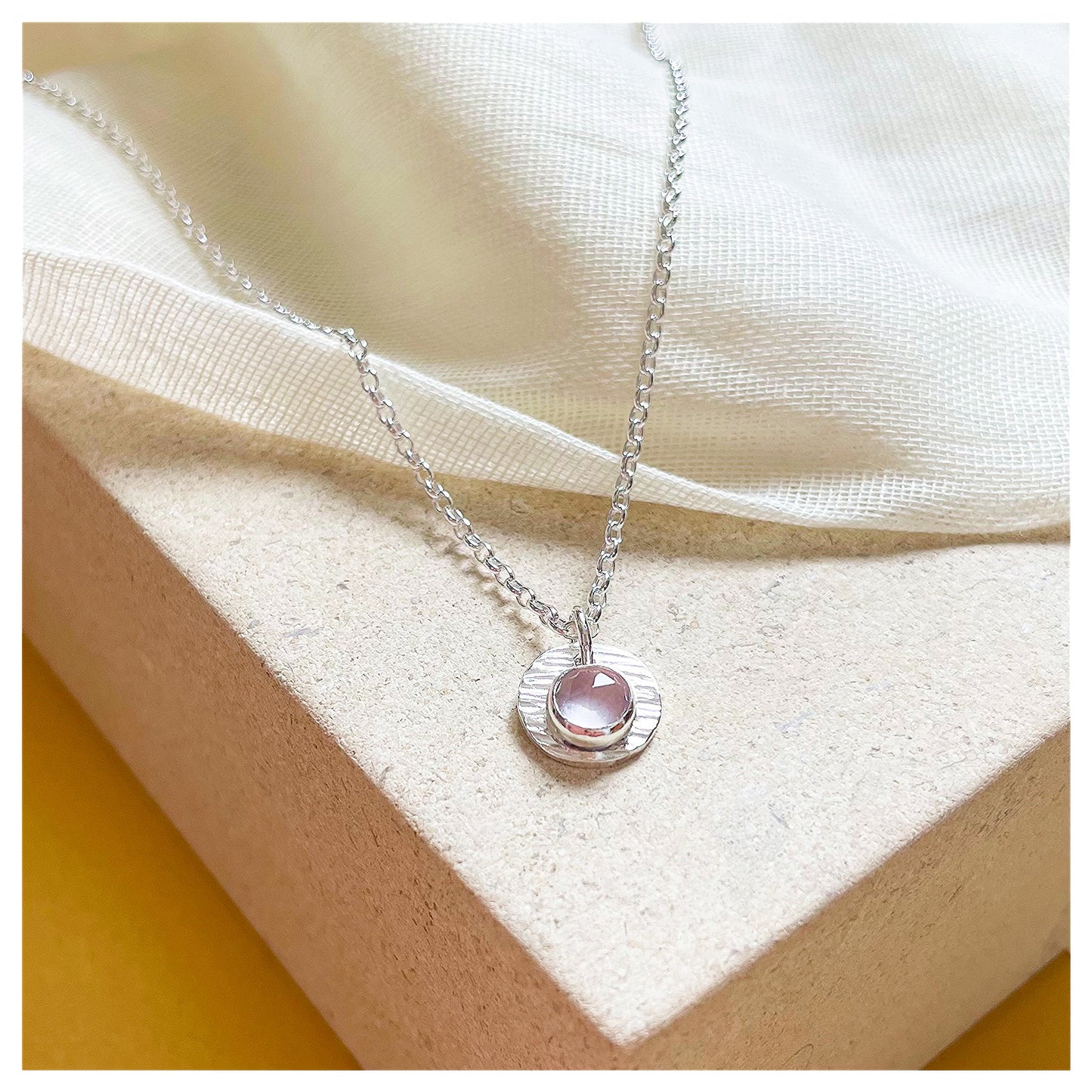 Sterling Silver and Rose Quartz Hammered Disc Pendant.