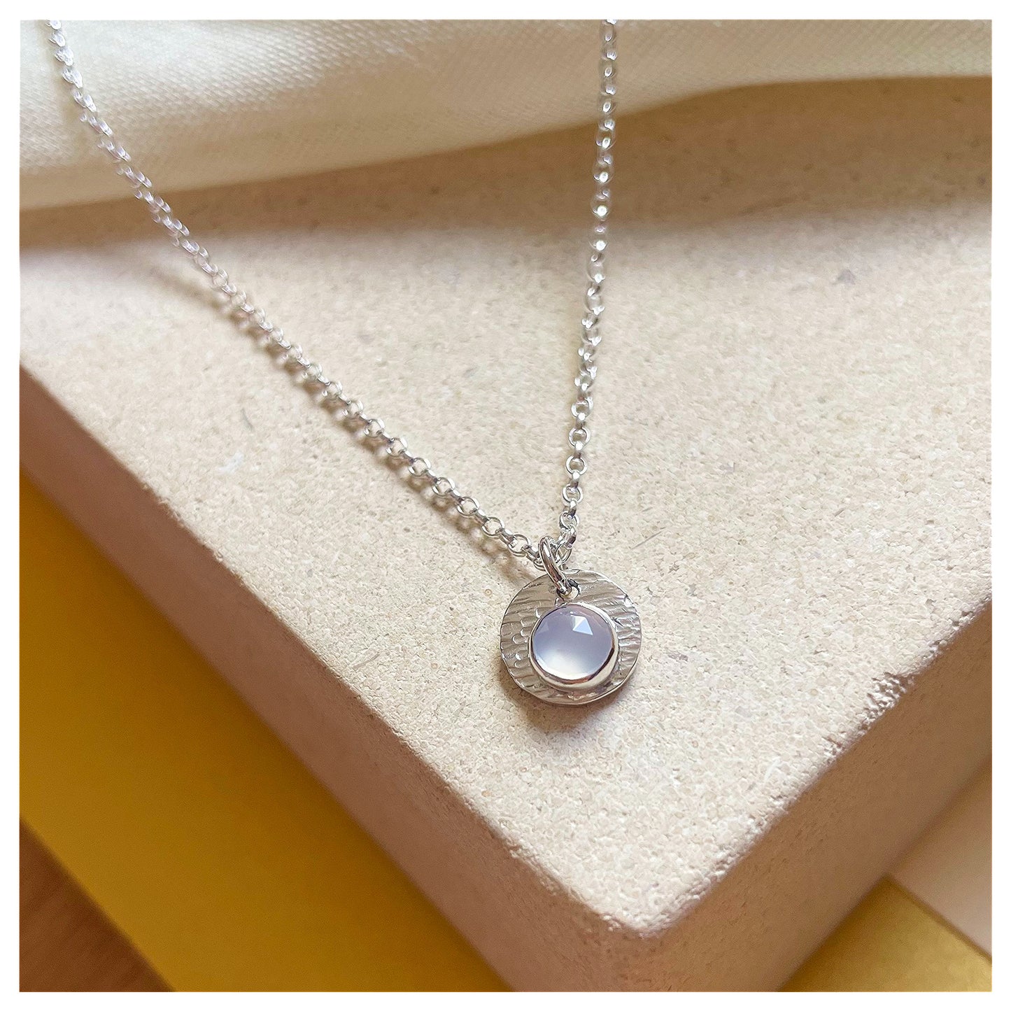 Sterling Silver and Chalcedony Hammered Disc Pendant.