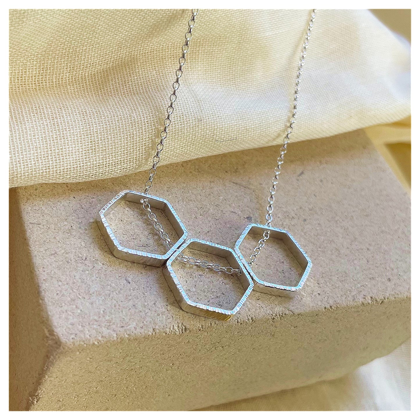Sterling Silver Textured Triple Hexagon Necklace.