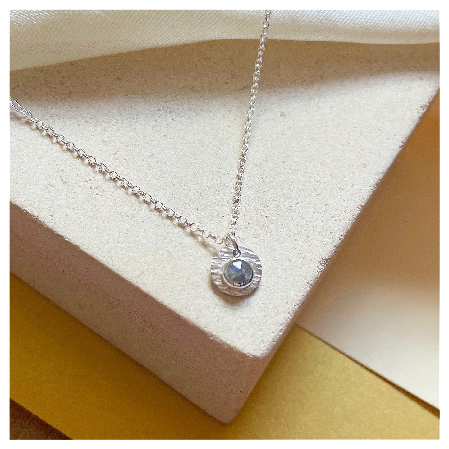 Sterling Silver and Labradorite Hammered Disc Pendant.