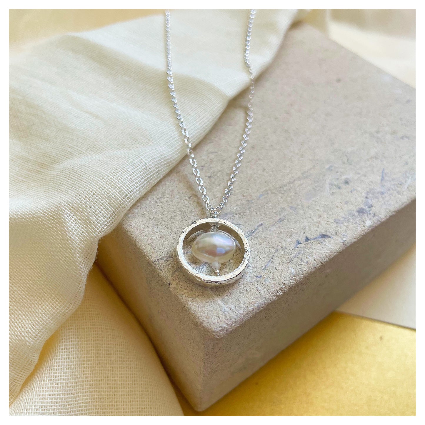 Sterling Silver Textured Circle Pendant Necklace with Freshwater Pearl and Moonstone.