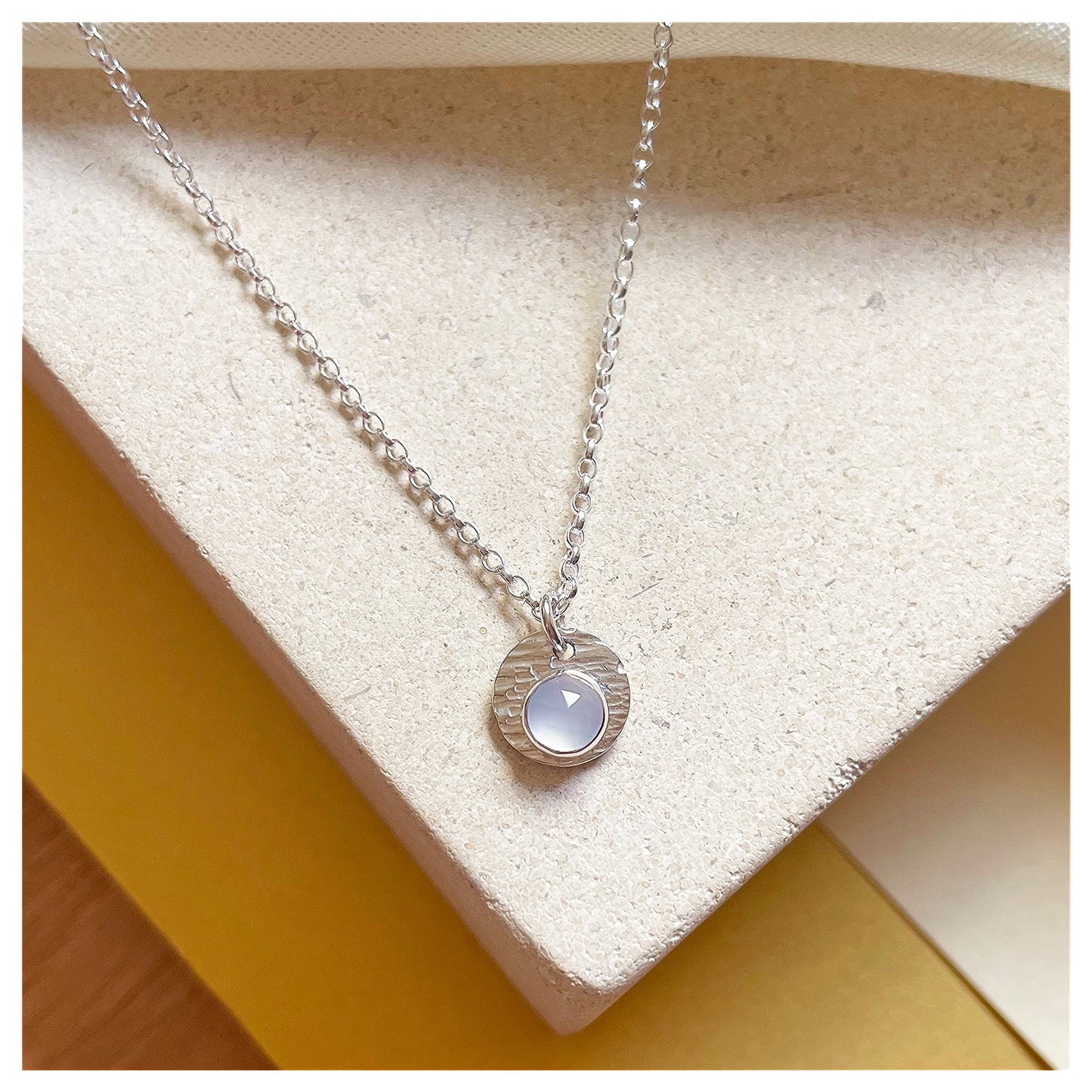Sterling Silver and Chalcedony Hammered Disc Pendant.