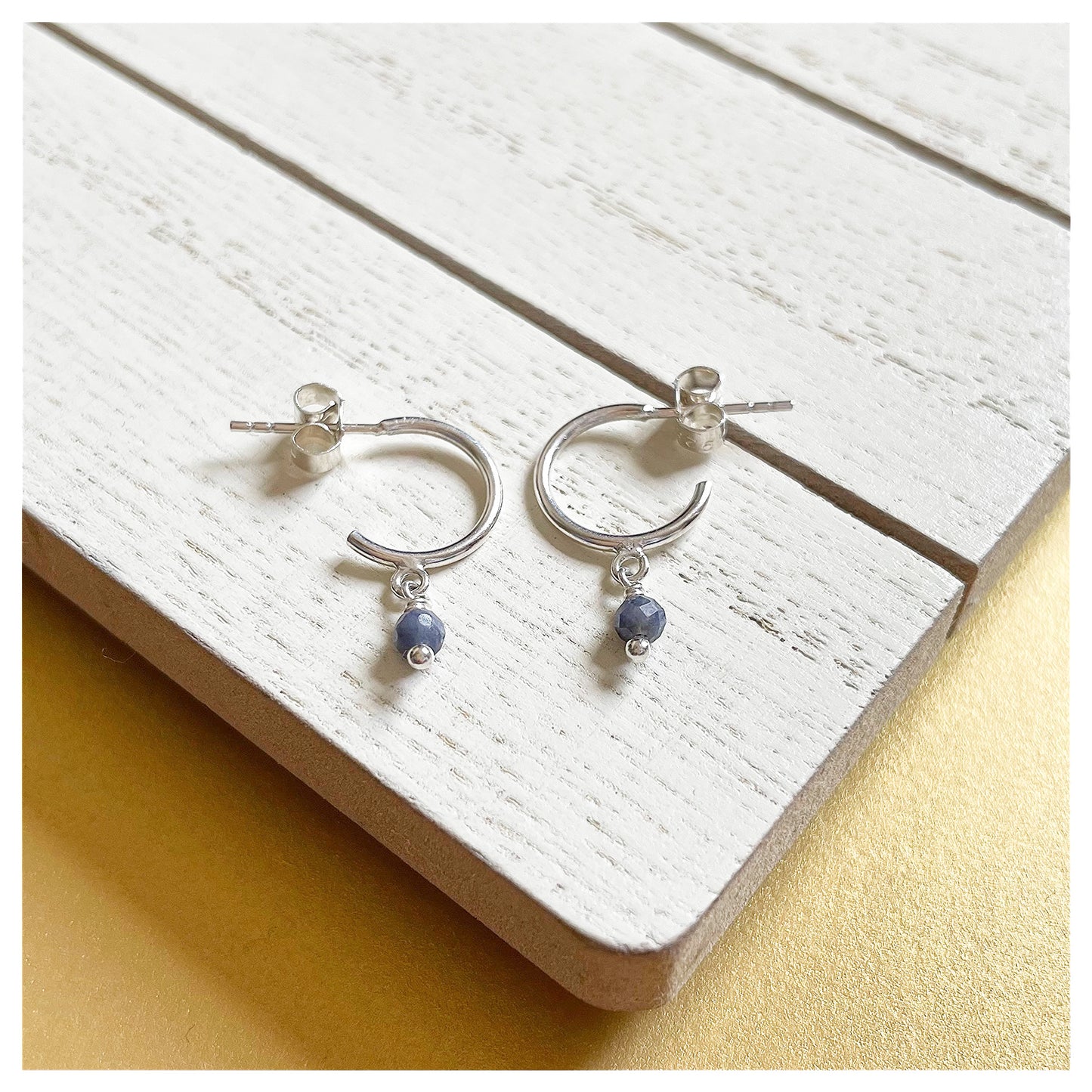 Sterling Silver and Blue Sapphire Small Half Hoop Earrings.